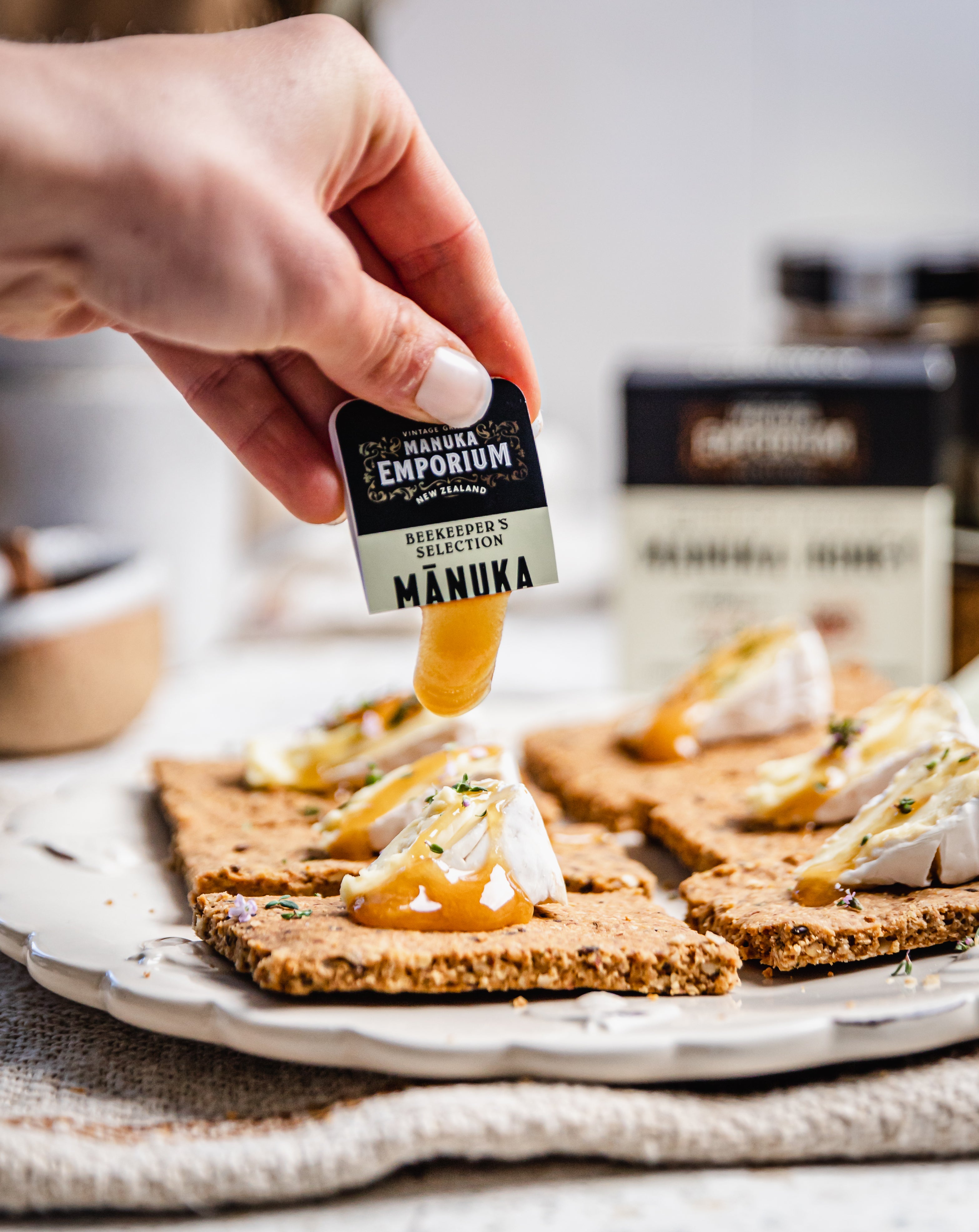 A Manuka Emporium snap squeezed onto crackers